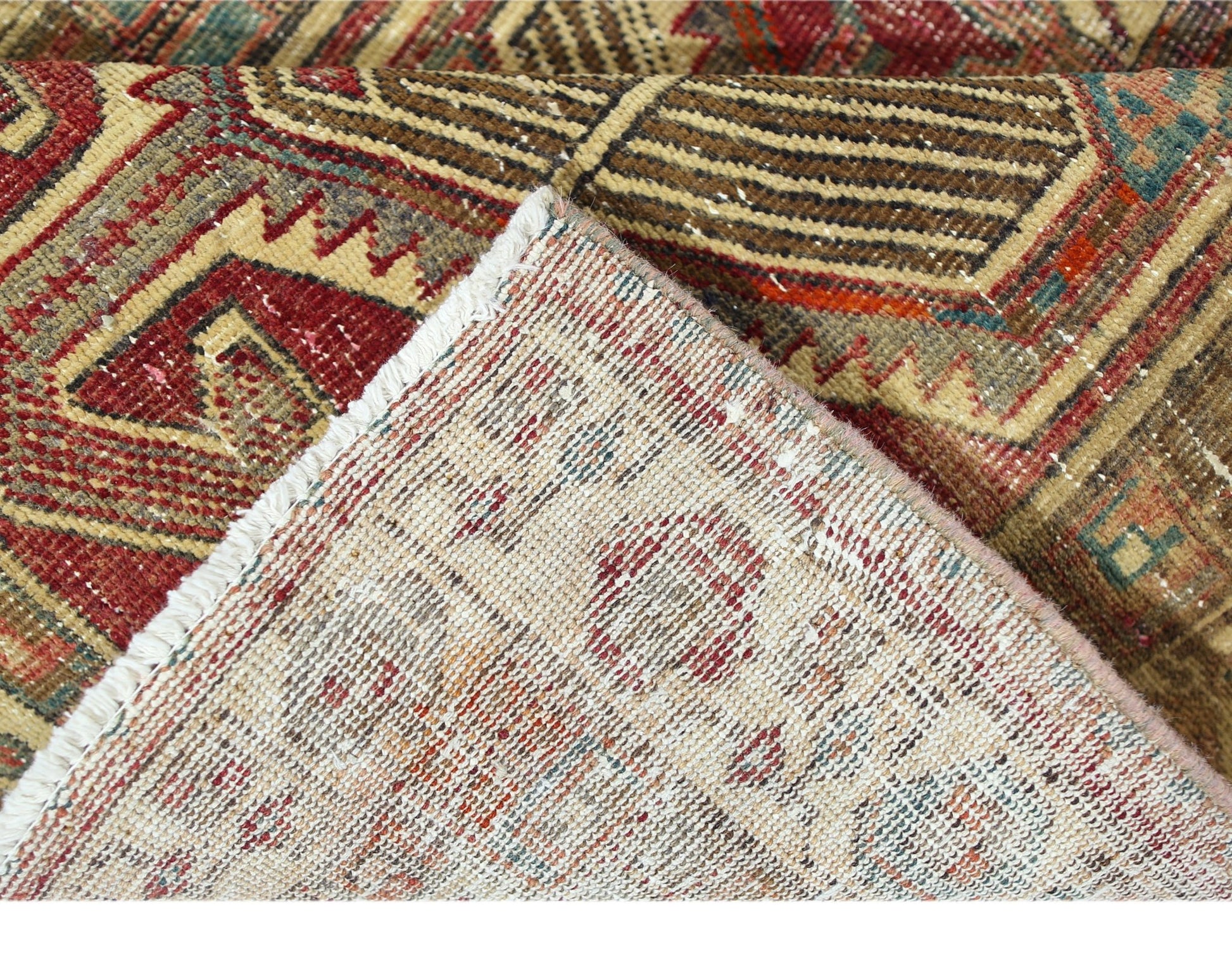 A vintage Persian Serab runner with a geometric pattern, showing the wool pile and cotton backing.