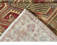 A vintage Persian Serab runner with a geometric pattern, showing the wool pile and cotton backing.