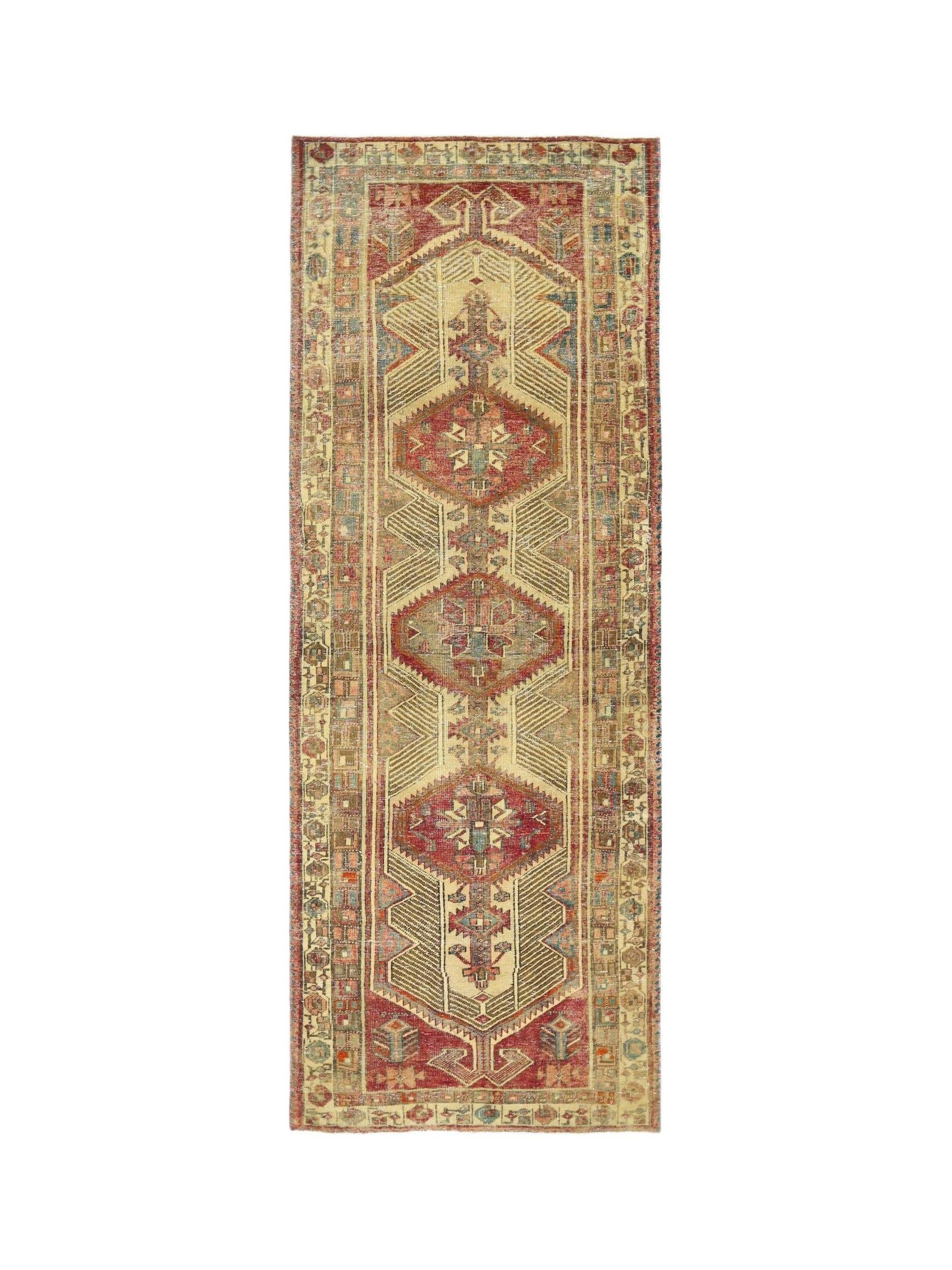 A vintage Persian Serab runner featuring three geometric medallions in red and blue on a tan field.