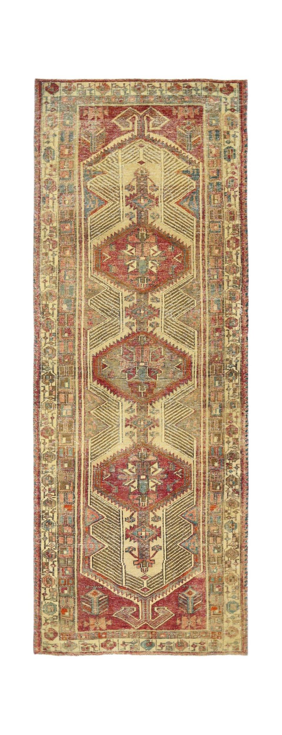 A vintage Persian Serab runner featuring three geometric medallions in red and blue on a tan field.