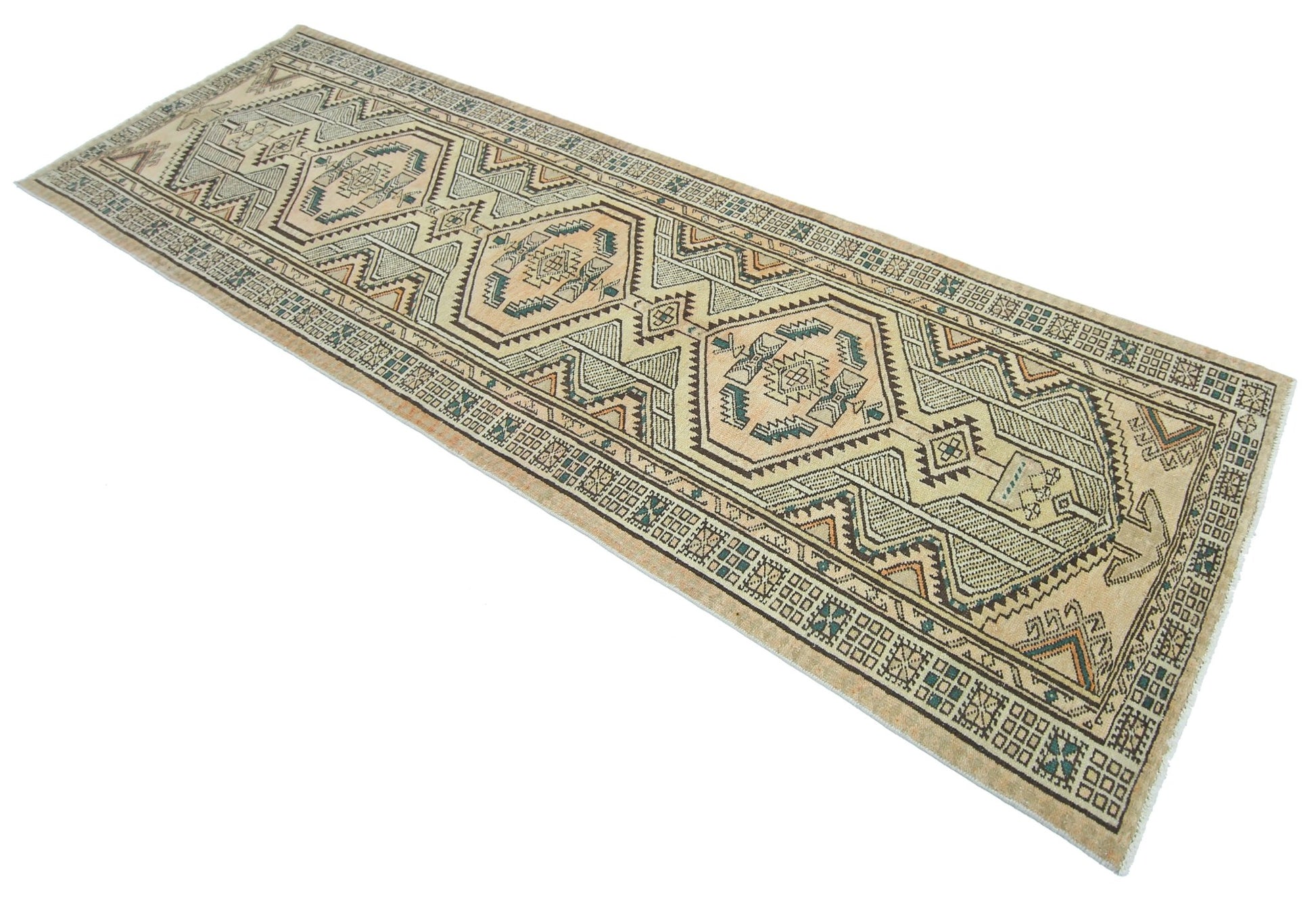 A vintage Persian Serab runner rug featuring geometric patterns in muted earth tones.