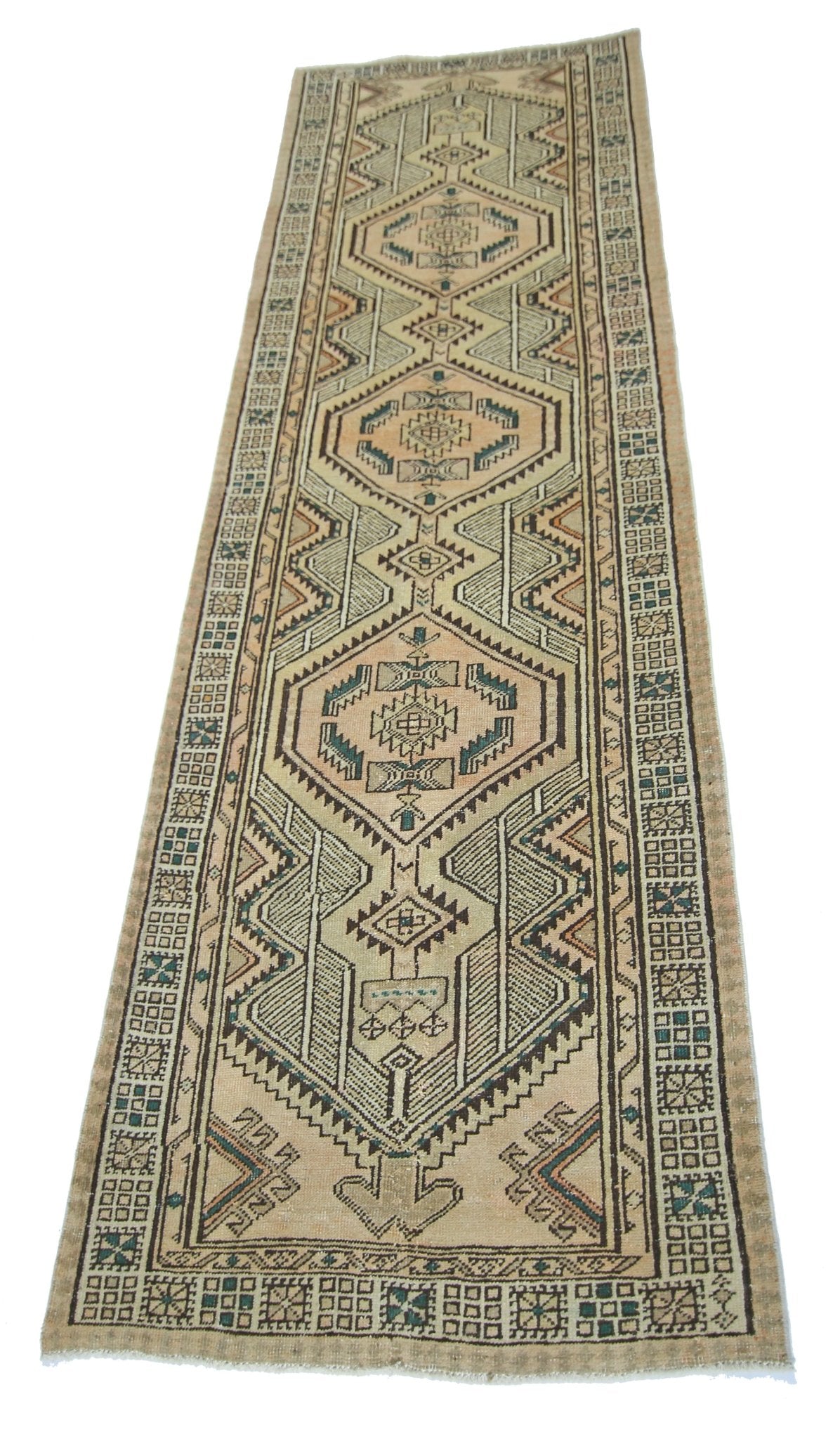 A vintage Persian Serab runner rug featuring geometric diamond patterns in muted earth tones.