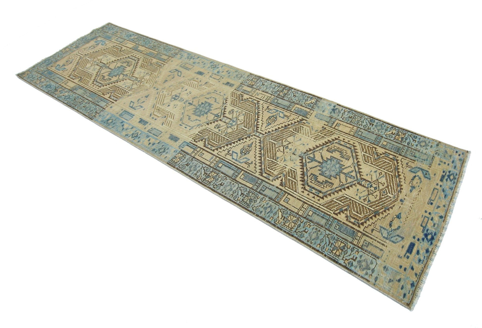 A vintage Persian Serab runner rug featuring geometric patterns in shades of blue and beige.