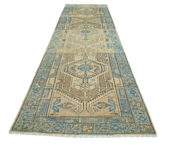 A vintage Persian Serab runner rug featuring geometric patterns in shades of blue and beige.