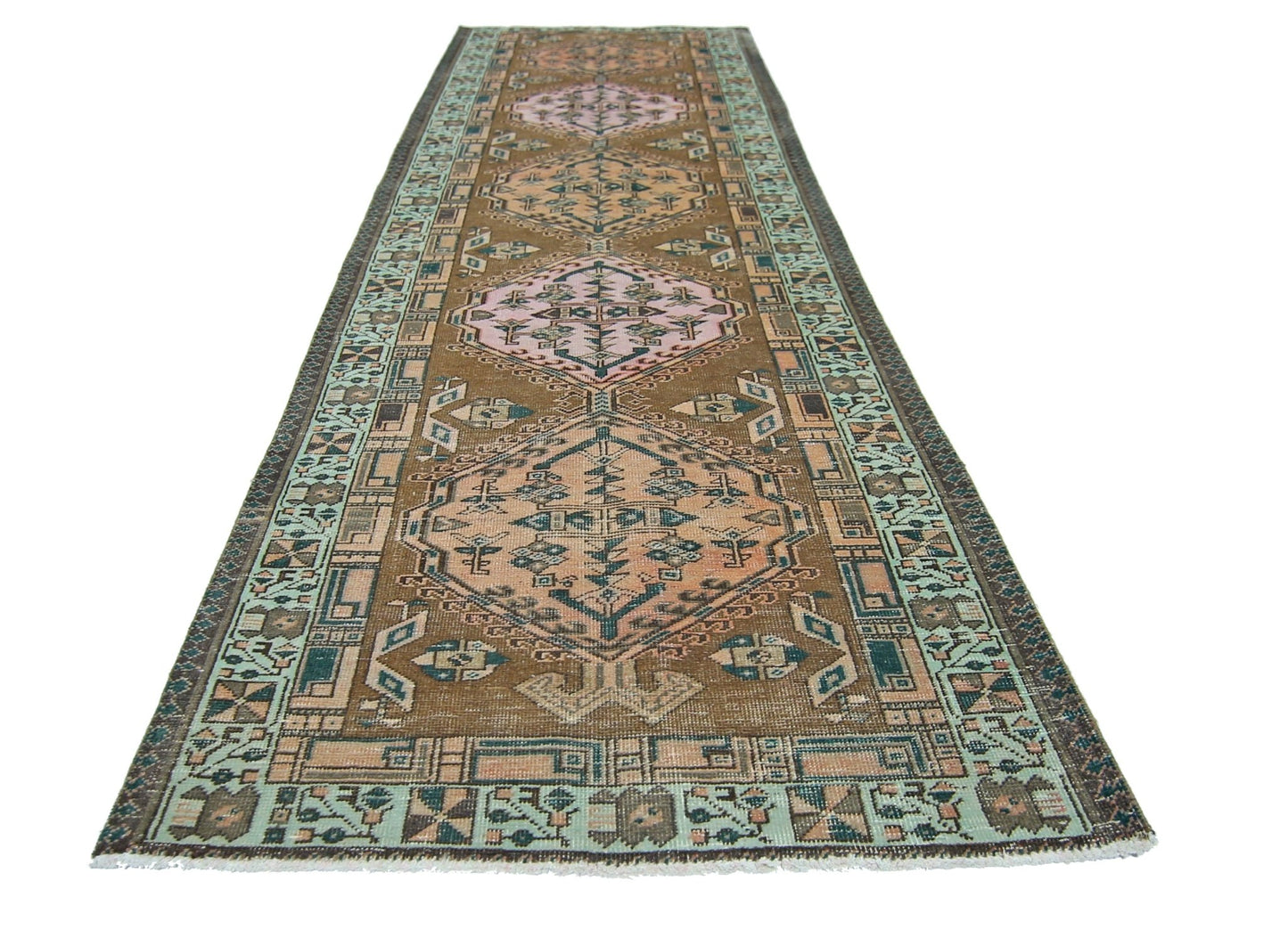 A vintage Persian Serab runner featuring geometric diamond medallions in pink and brown tones.