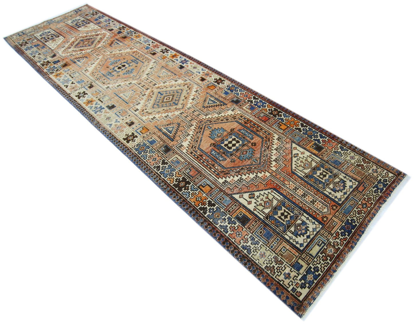 A vintage Persian Serab runner rug featuring geometric patterns in blue, orange, and cream tones.