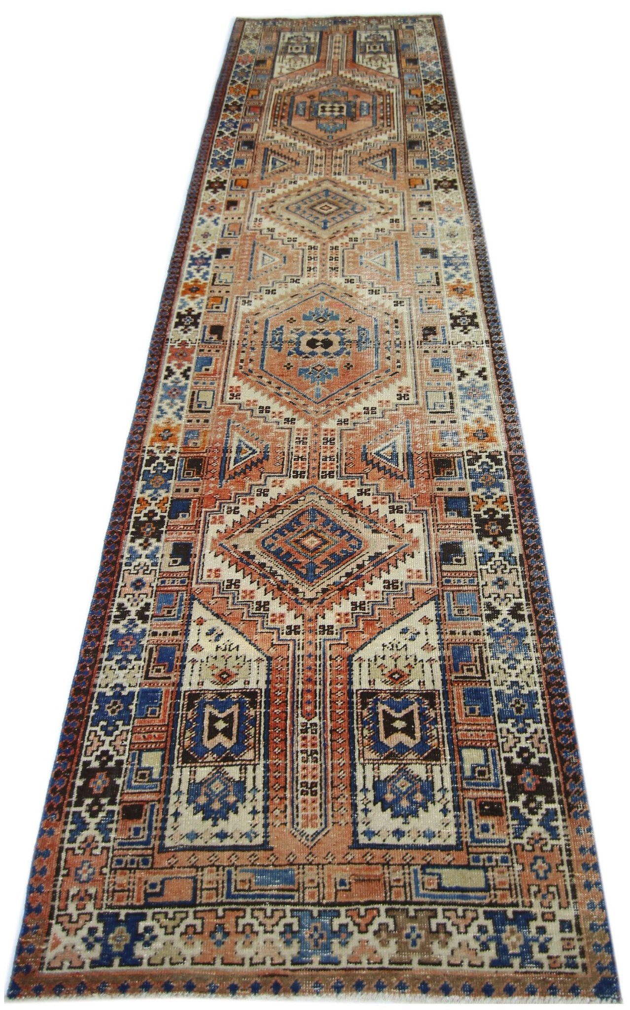 A vintage Persian Serab runner featuring geometric patterns in shades of blue, orange, and cream.