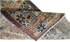 A vintage Persian Serab runner featuring intricate geometric patterns in blue, orange, and cream.