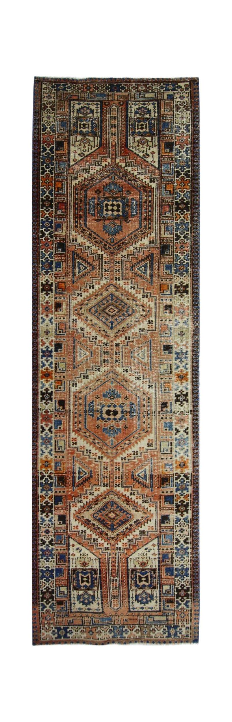 A vintage Persian Serab runner featuring geometric medallions in rust, blue, and cream tones.