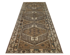 A vintage Persian Serab runner featuring geometric patterns in shades of brown and beige.