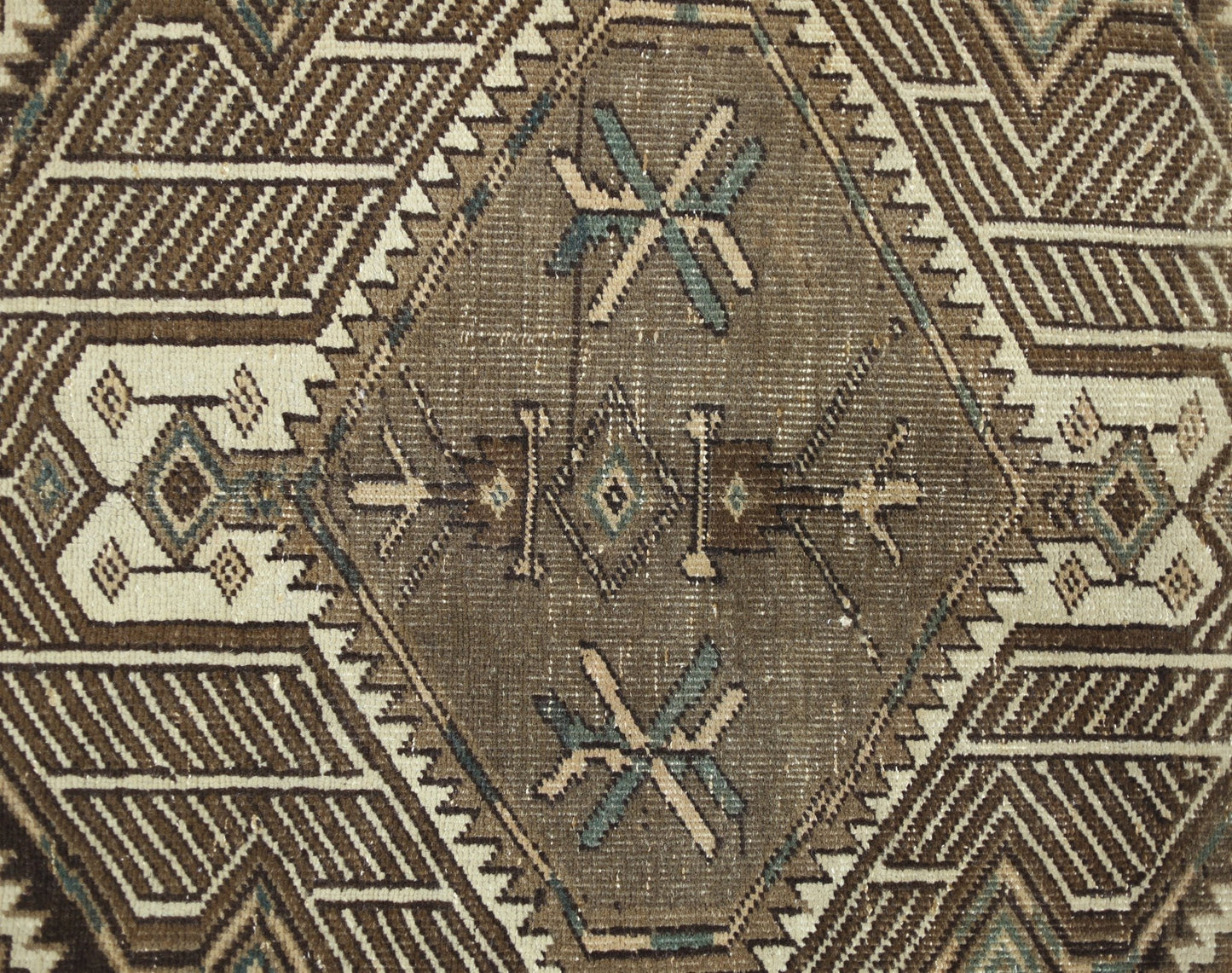A vintage Persian Serab runner featuring a geometric diamond pattern in brown and cream tones.