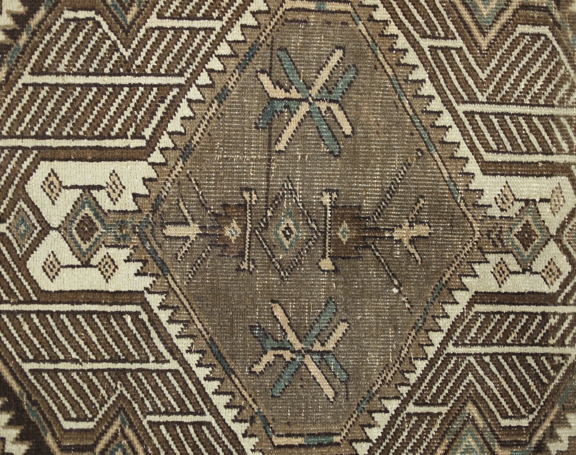 A vintage Persian Serab runner featuring a geometric diamond pattern in brown and cream tones.
