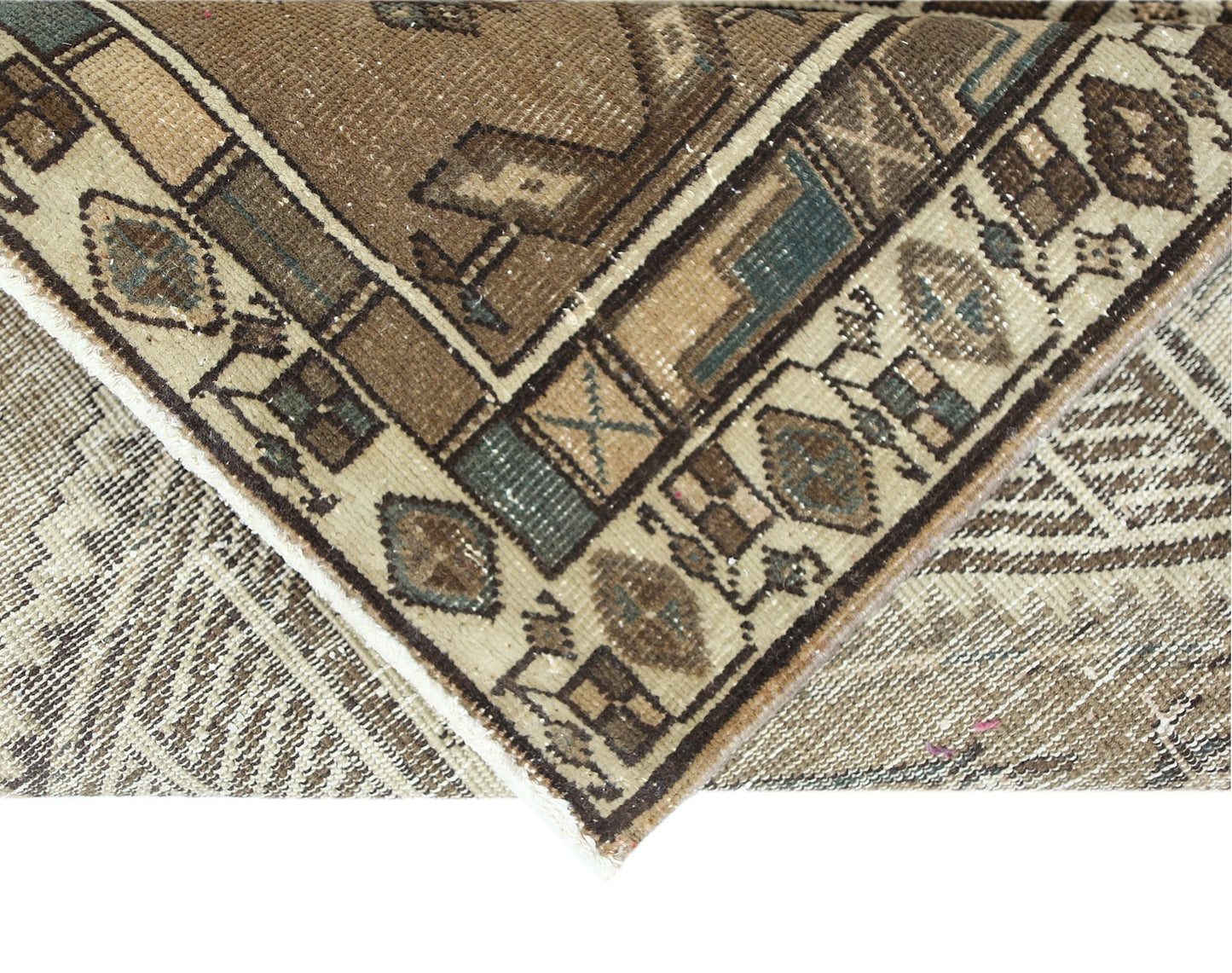 A corner view of a vintage Persian Serab runner featuring geometric patterns in brown and beige.