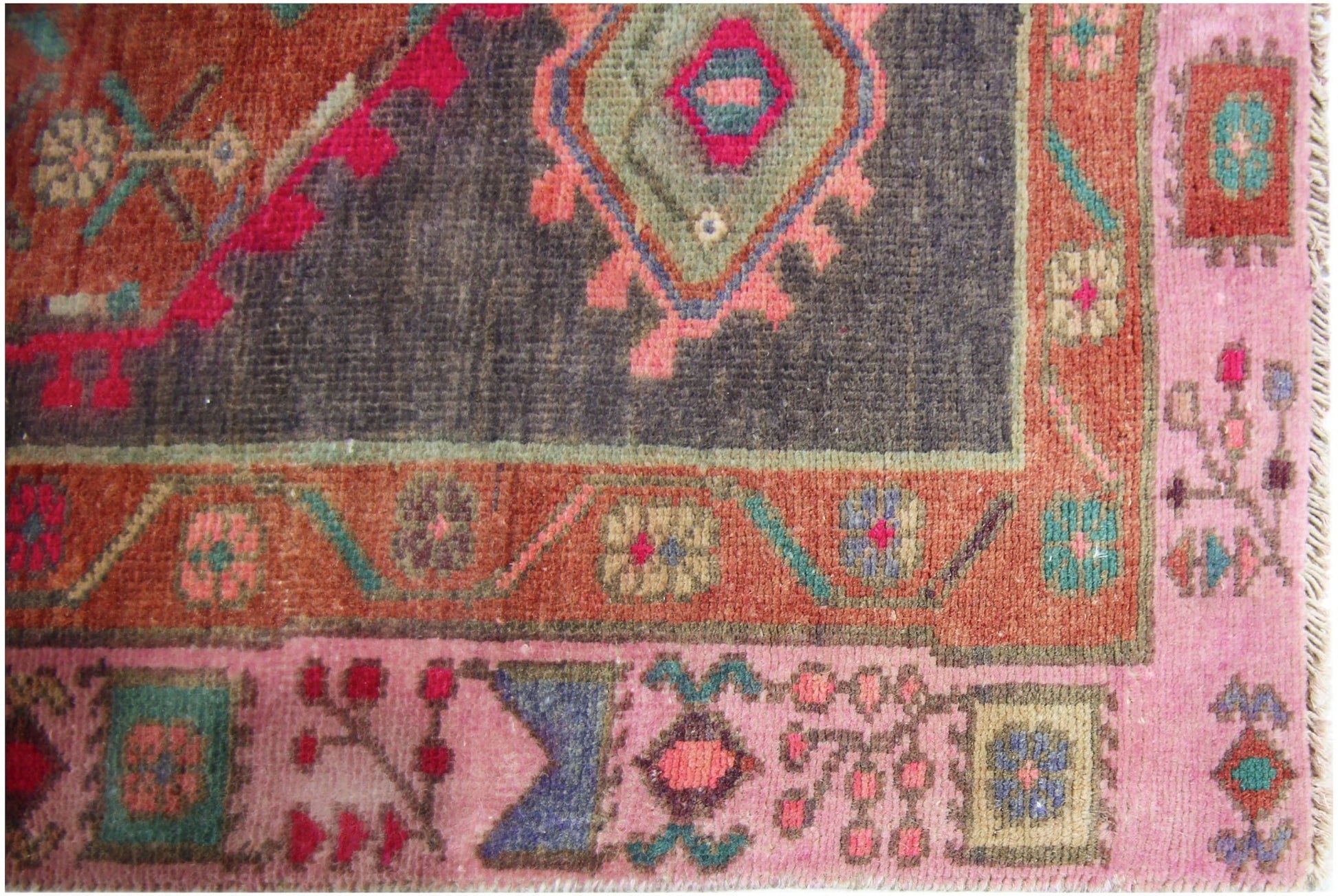 A vintage Persian Hamadan runner featuring a dark central medallion and colorful floral borders.
