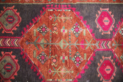 A vintage Persian Hamadan runner featuring a central orange diamond medallion on a dark field.