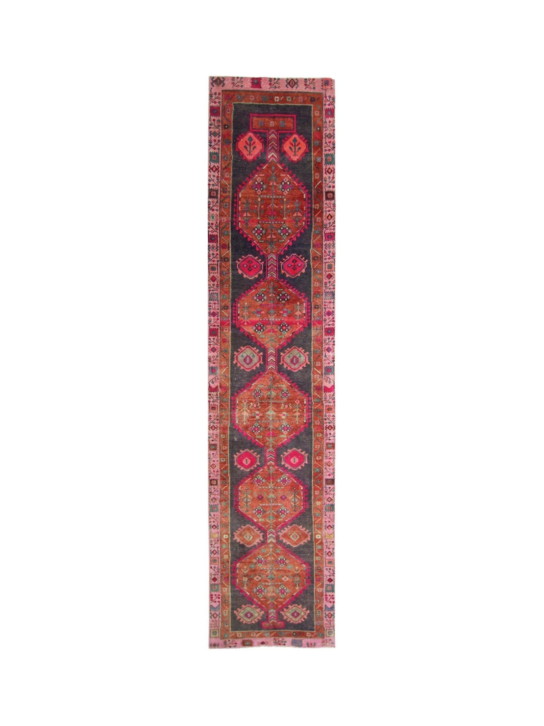 A vintage Persian Hamadan runner featuring geometric medallions in red and dark blue tones.