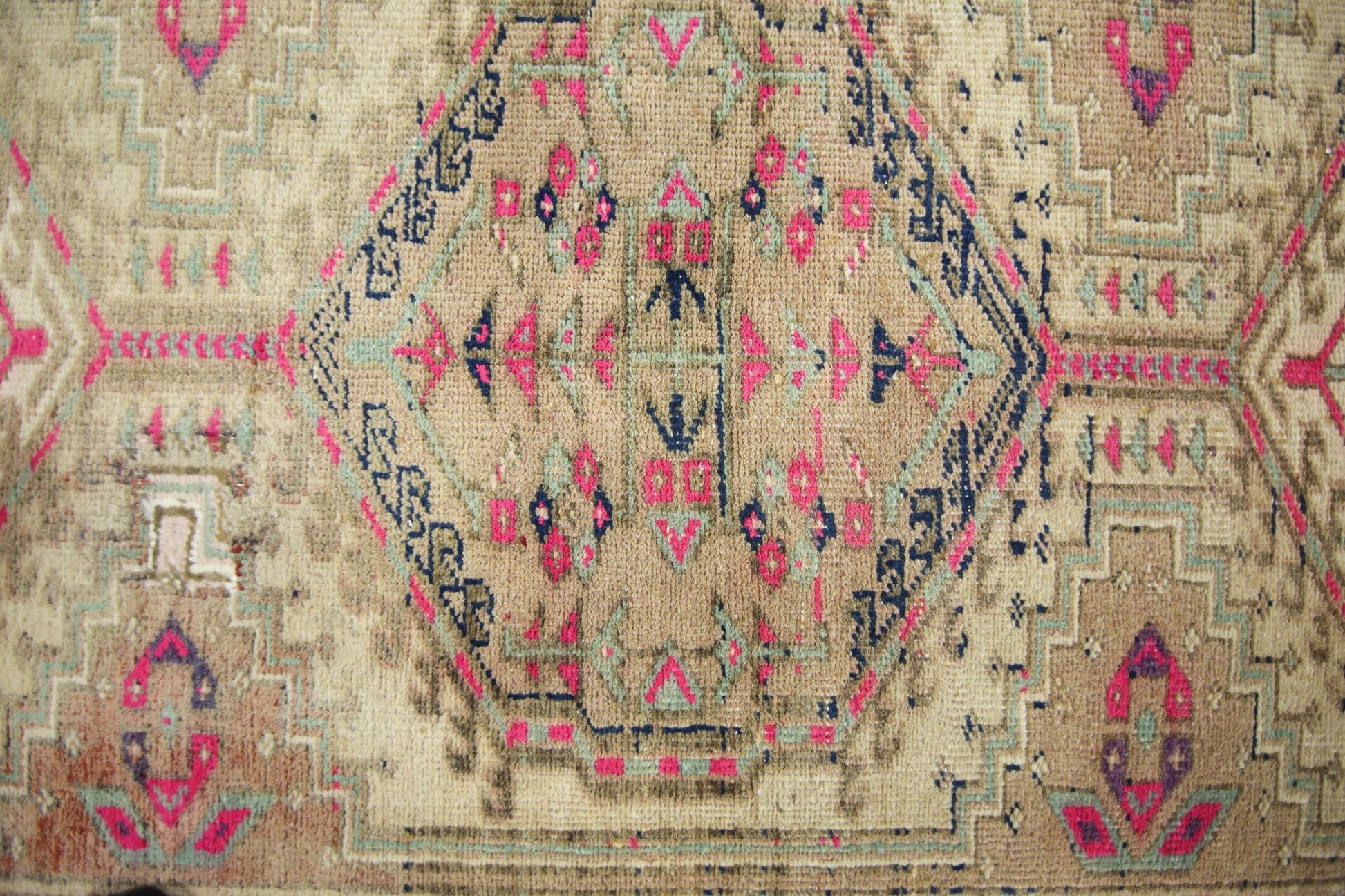 A vintage Persian Hamadan runner featuring a geometric medallion pattern in pink, blue, and tan.