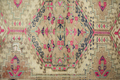 A vintage Persian Hamadan runner featuring a geometric medallion pattern in pink, blue, and tan.