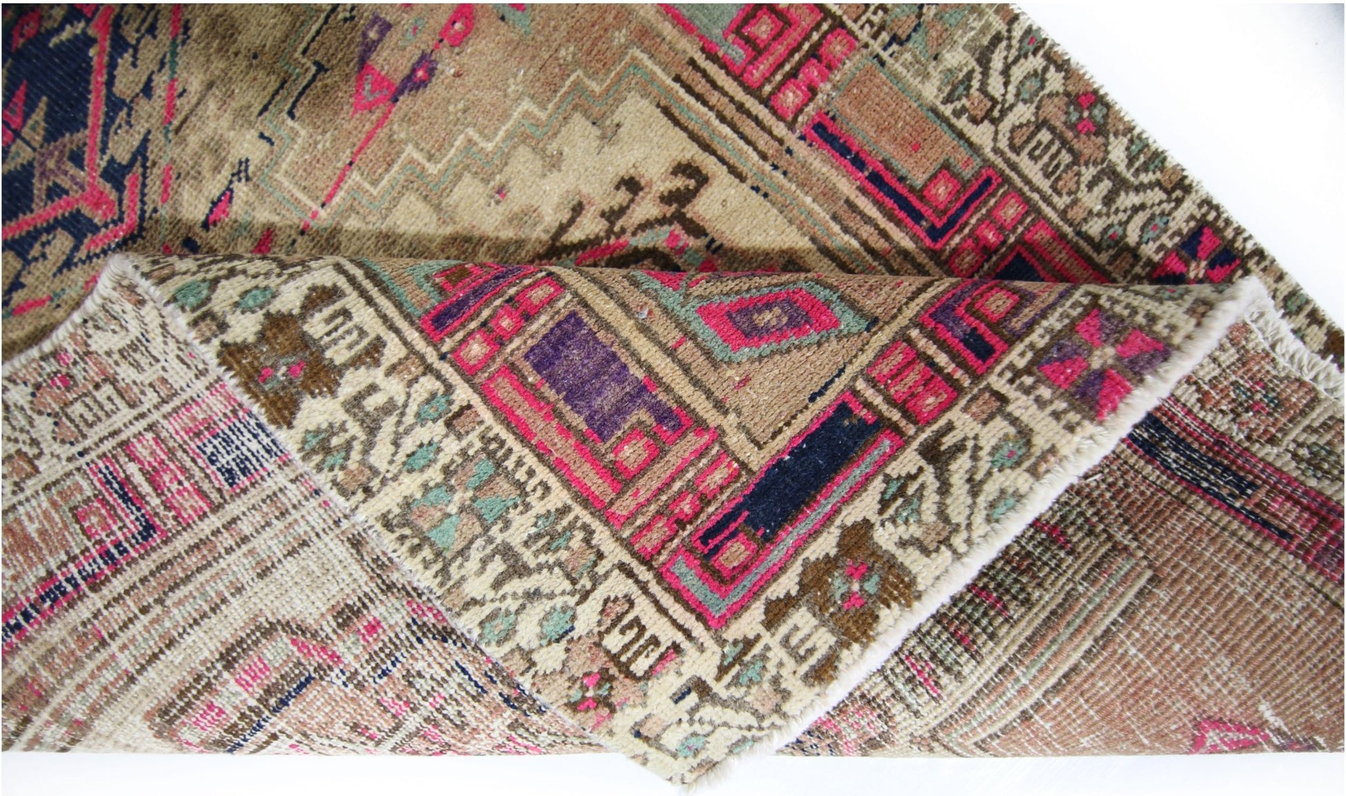 A vintage Persian Hamadan runner featuring intricate geometric patterns in vibrant pink and blue.