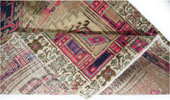 A vintage Persian Hamadan runner featuring intricate geometric patterns in vibrant pink and blue.