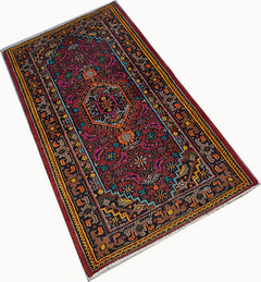 A rectangular vintage Persian Shiraz rug featuring a geometric pattern in red, blue, and orange.