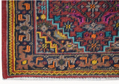 A vintage Persian Shiraz rug featuring a geometric red field with blue, yellow, and orange accents.