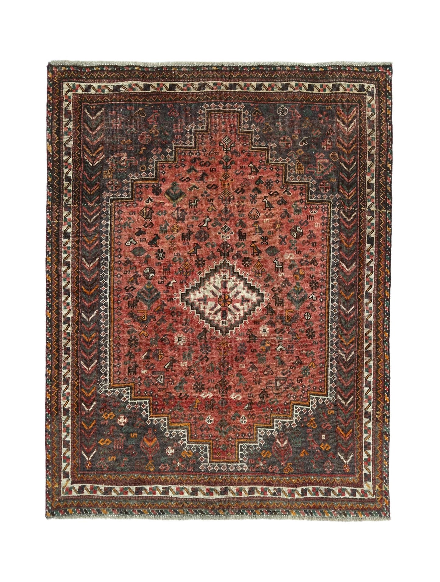 A handwoven vintage Persian Shiraz rug featuring a central geometric medallion on a red field.