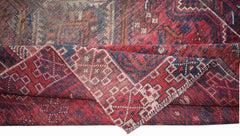 A vintage handwoven Persian Shiraz rug featuring a geometric pattern in red and blue wool.