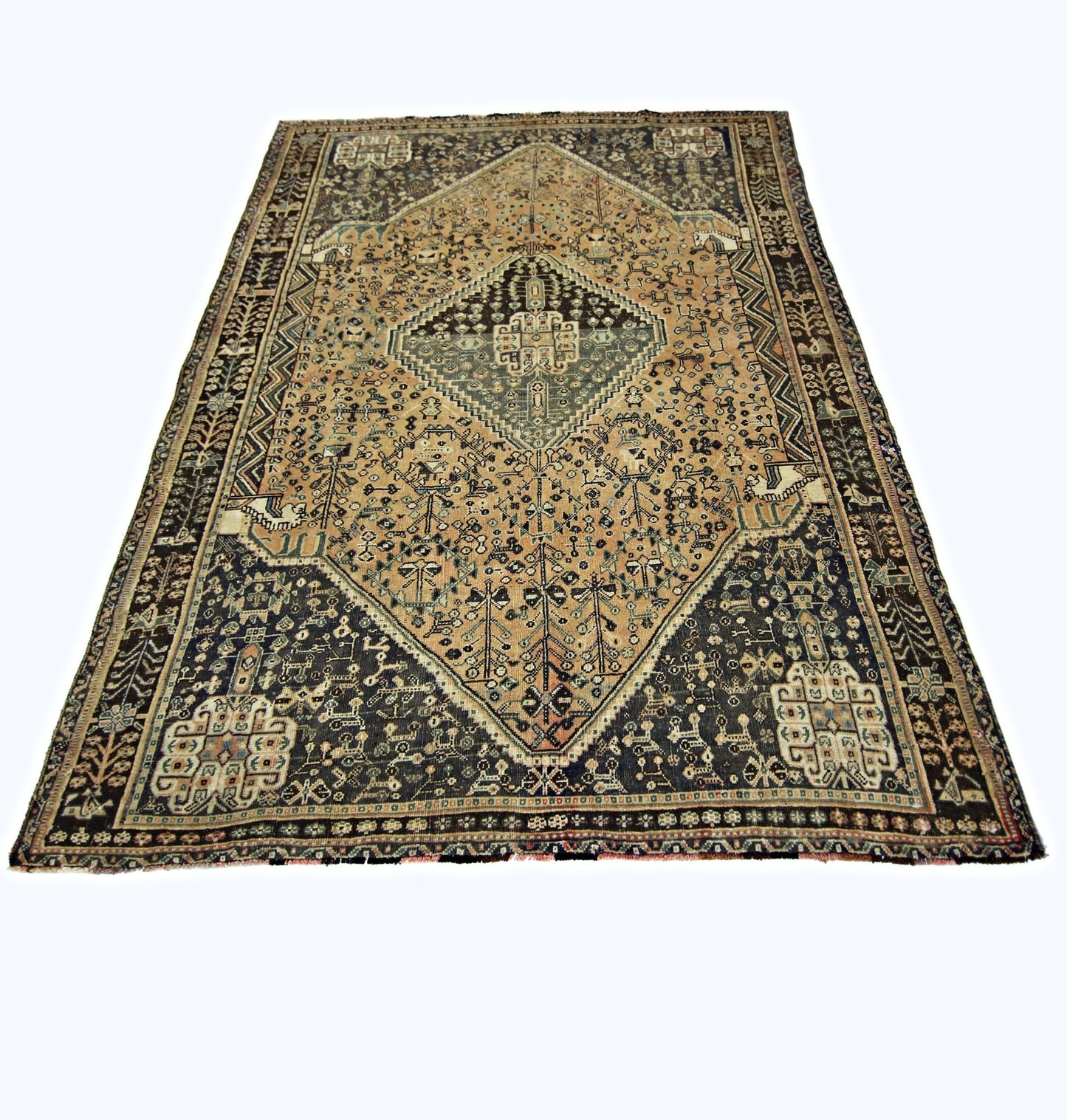 A vintage handmade Persian Shiraz rug featuring a central diamond medallion on a tan and dark field.