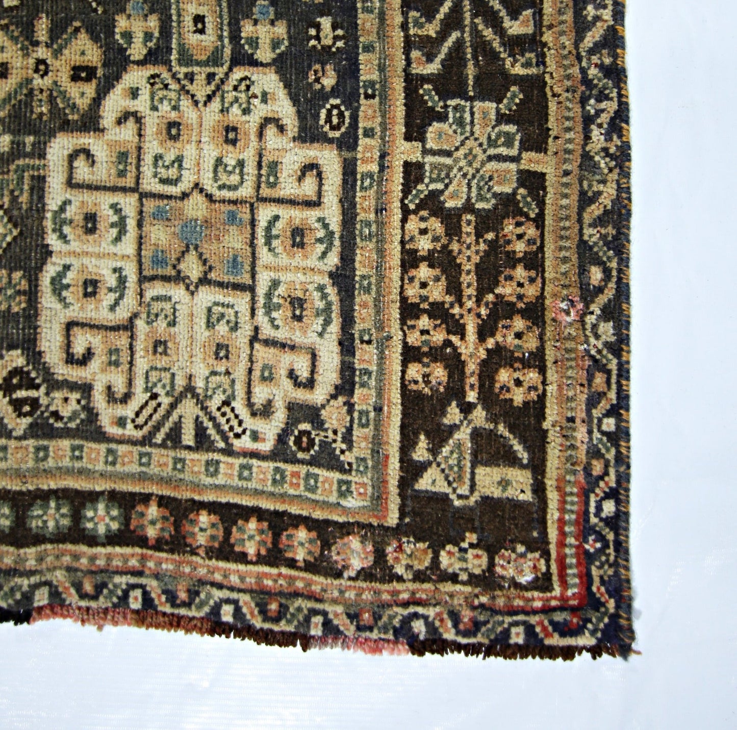 A vintage Persian Shiraz rug featuring a geometric central medallion and intricate floral borders.