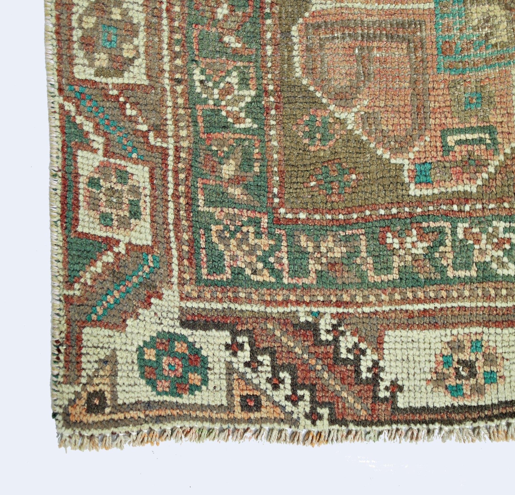 A corner view of a vintage Persian Shiraz rug featuring intricate geometric patterns in wool.