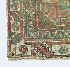 A corner view of a vintage Persian Shiraz rug featuring intricate geometric patterns in wool.
