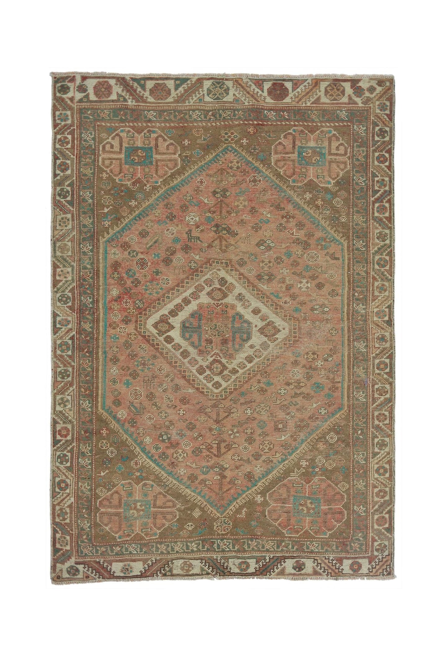 A vintage Persian Shiraz rug featuring a large central diamond medallion on a muted pink field.