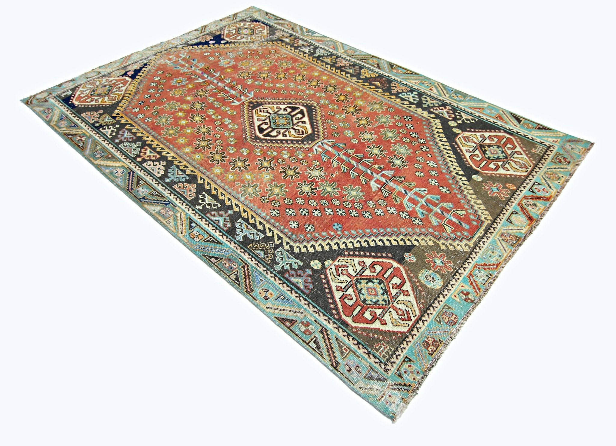 A vintage handmade Persian Shiraz rug featuring a geometric pattern in red, blue, and brown tones.