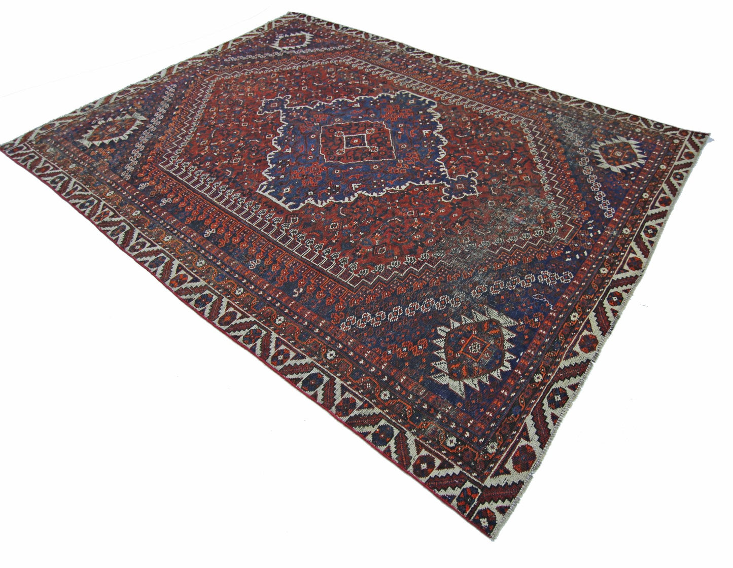 A vintage Persian Shiraz rug featuring a traditional geometric pattern in red and blue tones.