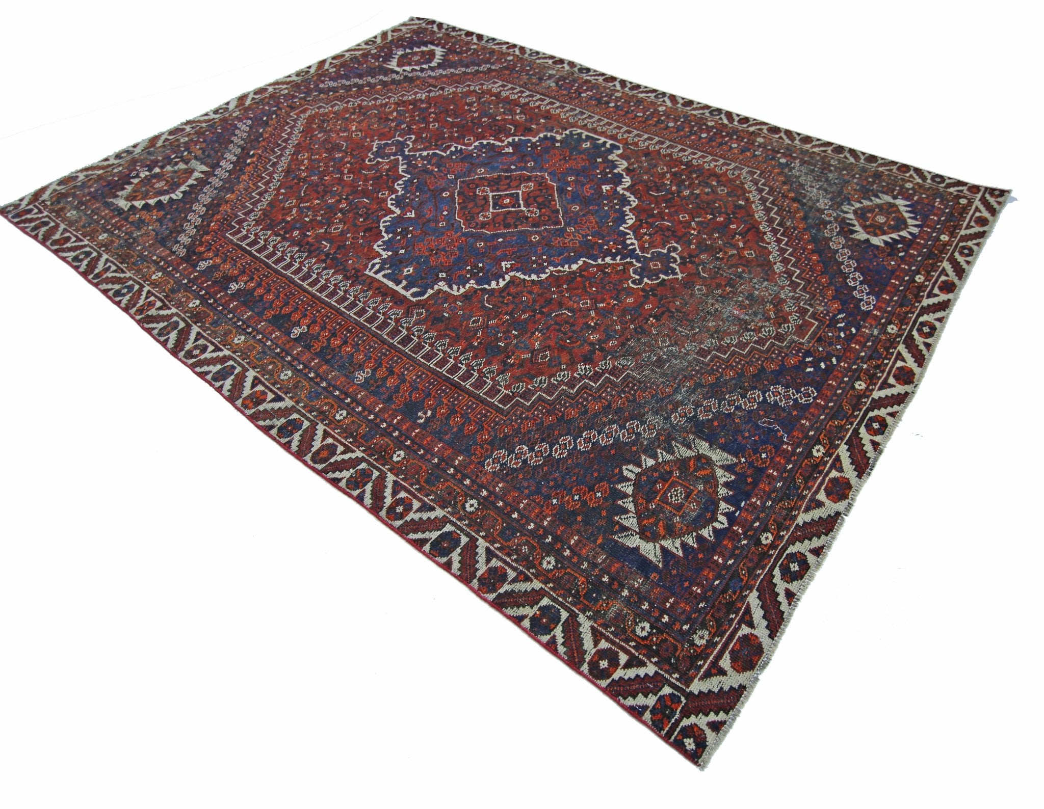 A vintage Persian Shiraz rug featuring a traditional geometric pattern in red and blue tones.