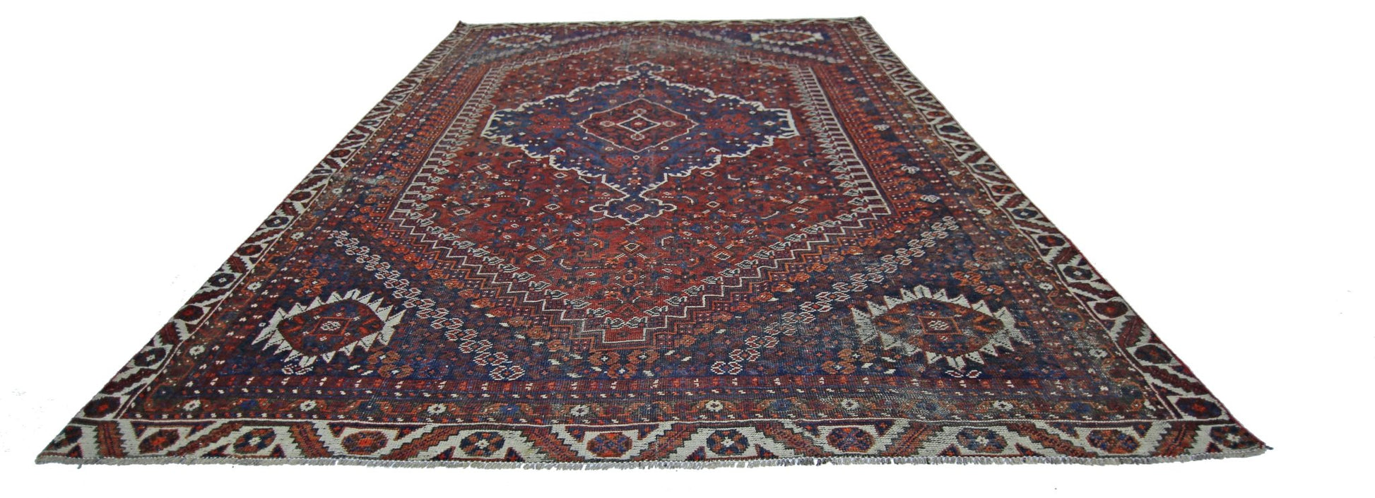 A vintage Persian Shiraz rug featuring a central medallion and intricate geometric patterns.