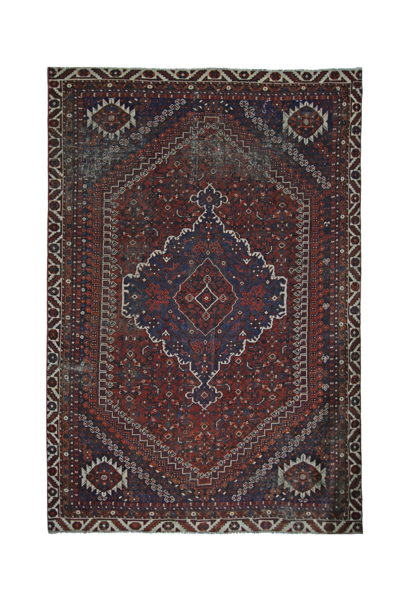 A vintage Persian Shiraz rug featuring a central diamond medallion on a deep red and blue field.