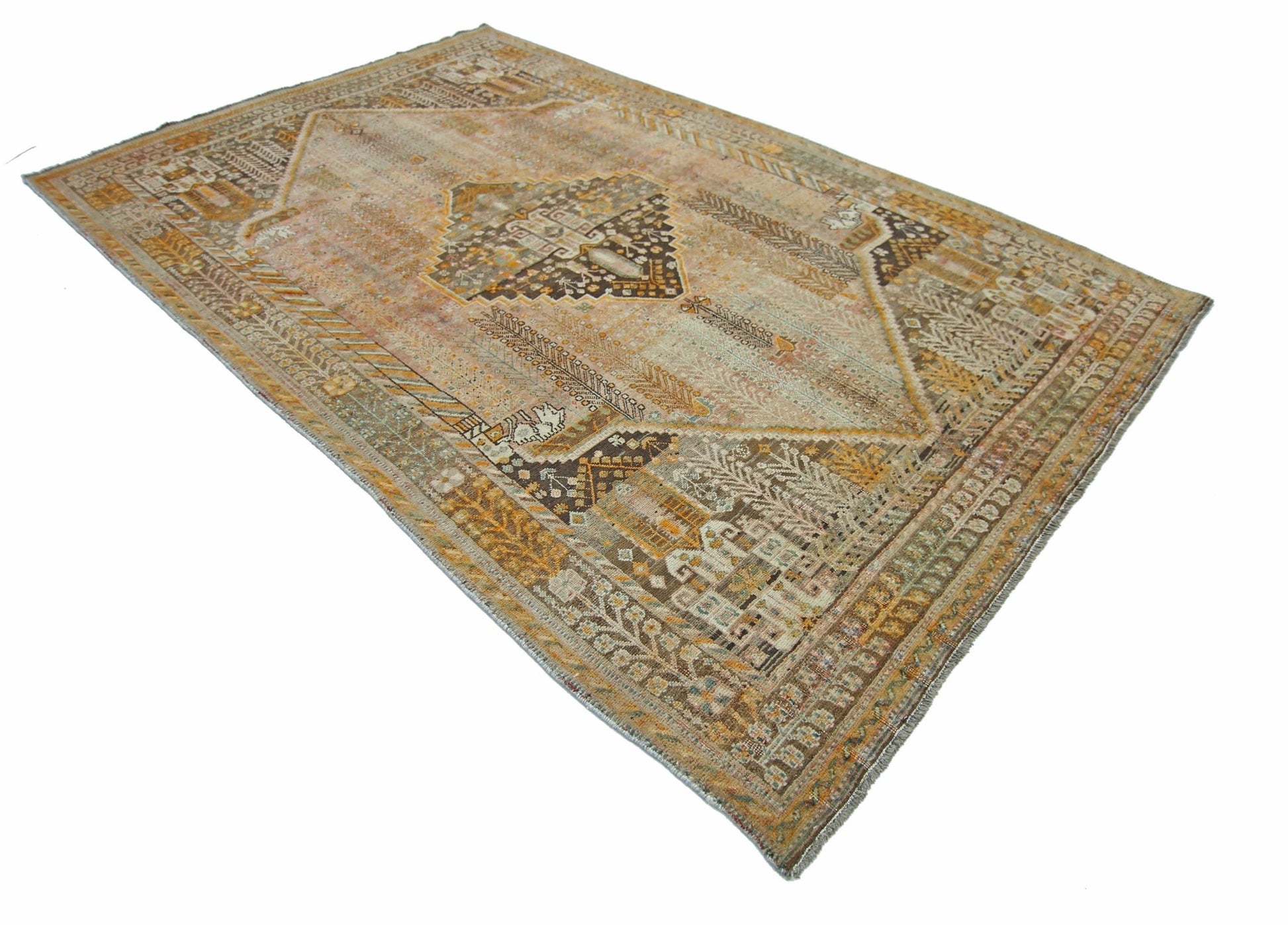 A vintage Persian Shiraz rug featuring a geometric medallion pattern in warm earth tones.