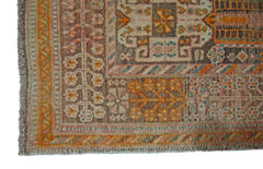 A corner view of a vintage Persian Shiraz rug featuring intricate geometric and floral patterns.