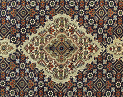 A vintage Persian Tabriz rug featuring an intricate floral medallion pattern in silk and wool.