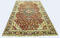 A rectangular vintage Persian rug featuring a central medallion on a red field with floral patterns.