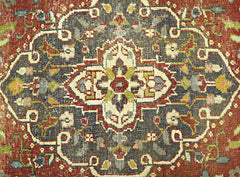 A vintage Persian rug featuring a detailed floral medallion pattern in shades of red and charcoal.