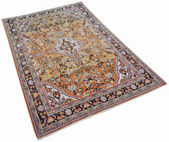 A vintage Persian Tabriz rug featuring an intricate floral pattern in orange and dark purple tones.