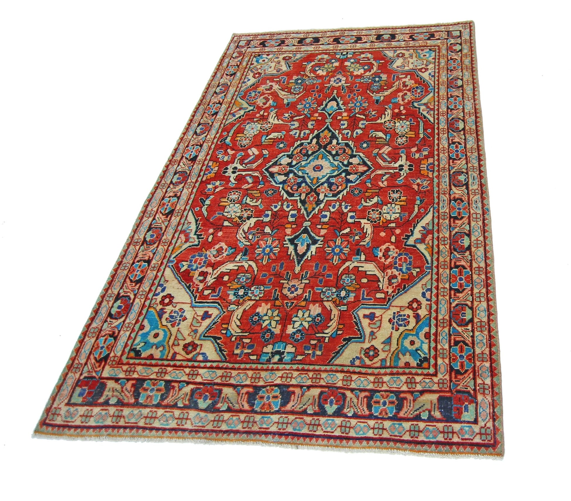 A vintage Persian Tabriz rug featuring a central floral medallion on a red field with ornate borders.