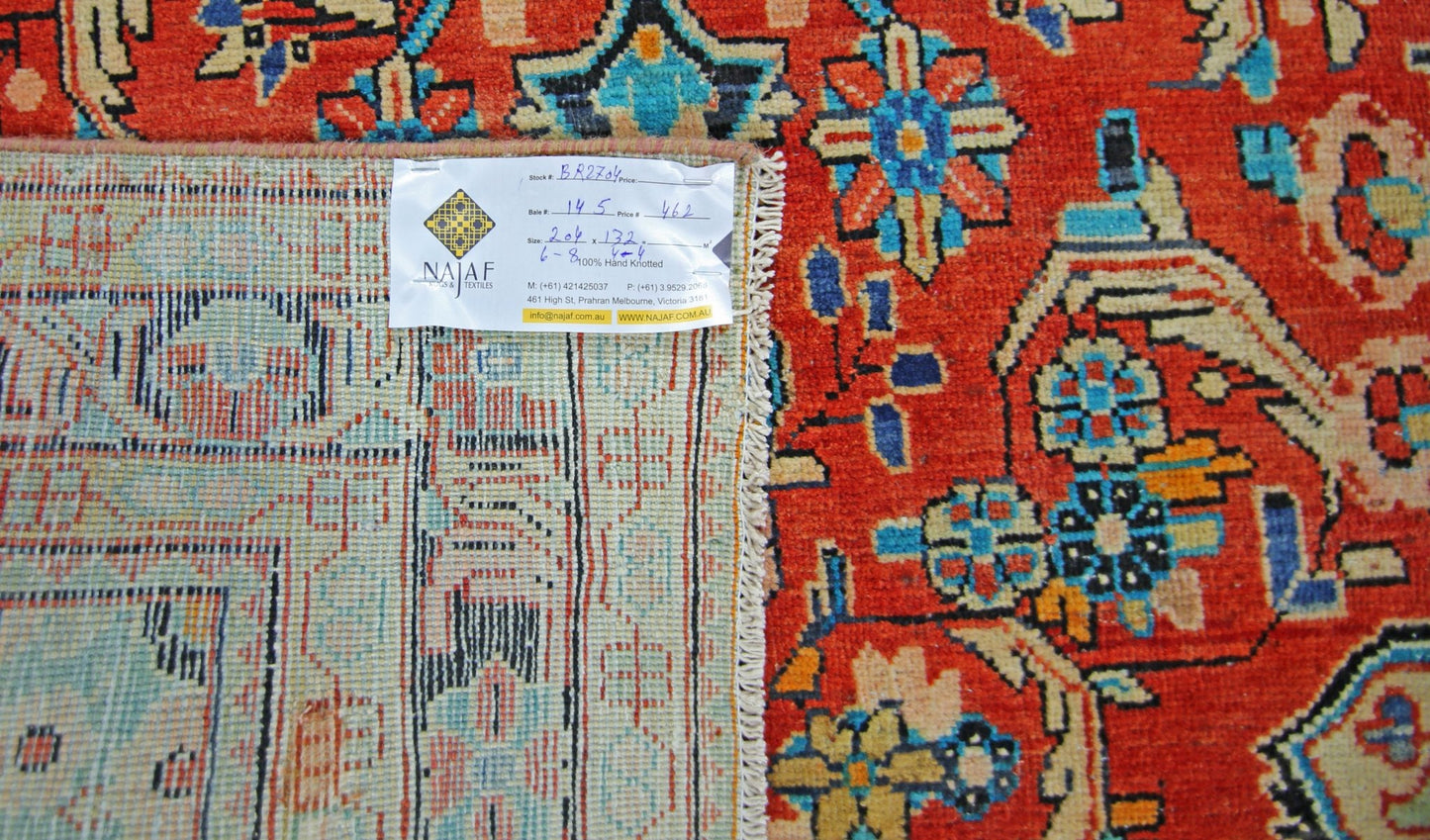 A vintage Persian Tabriz rug featuring a vibrant red field with intricate floral patterns.