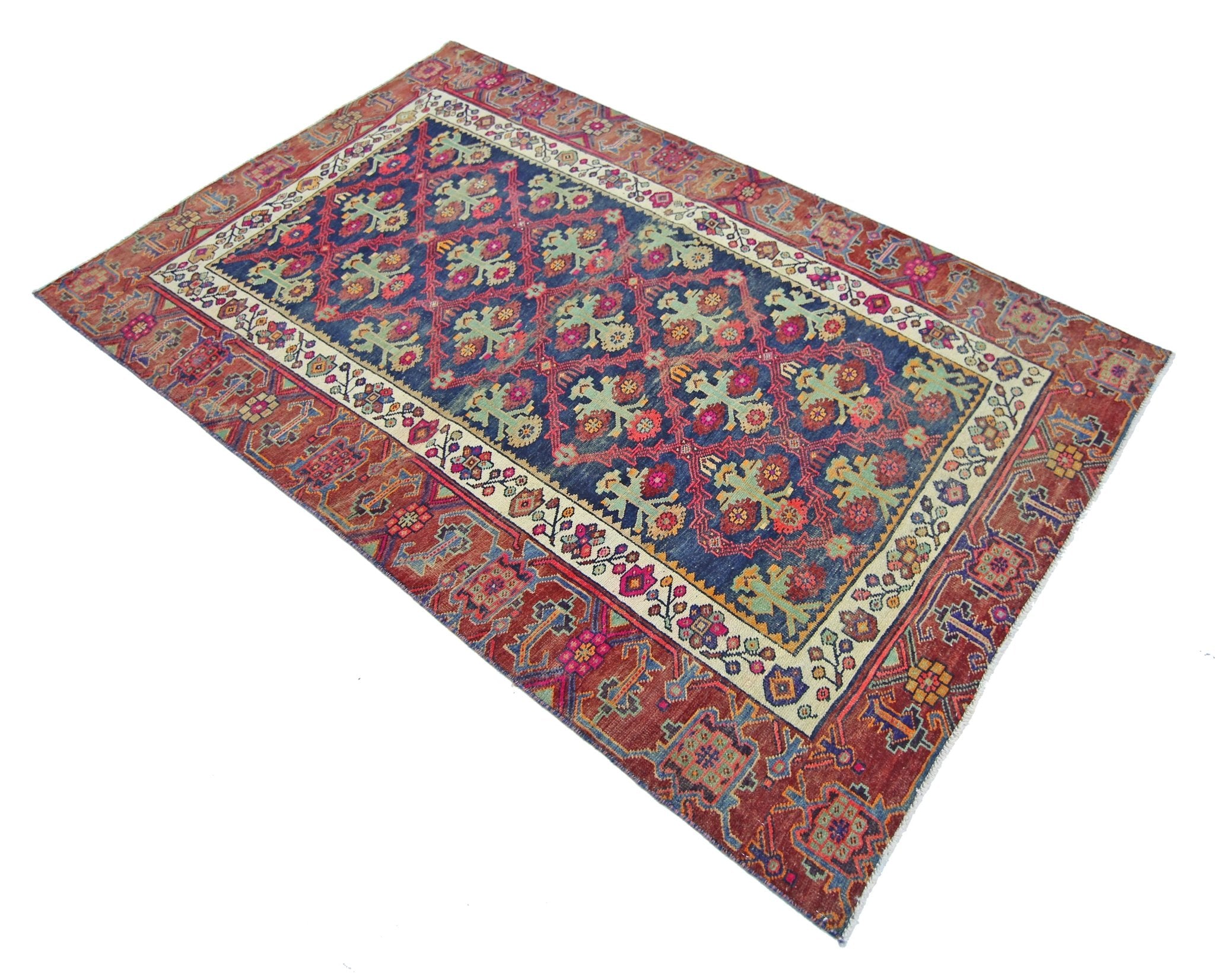 A vintage Persian Tabriz rug featuring a blue field with floral motifs and a red border.