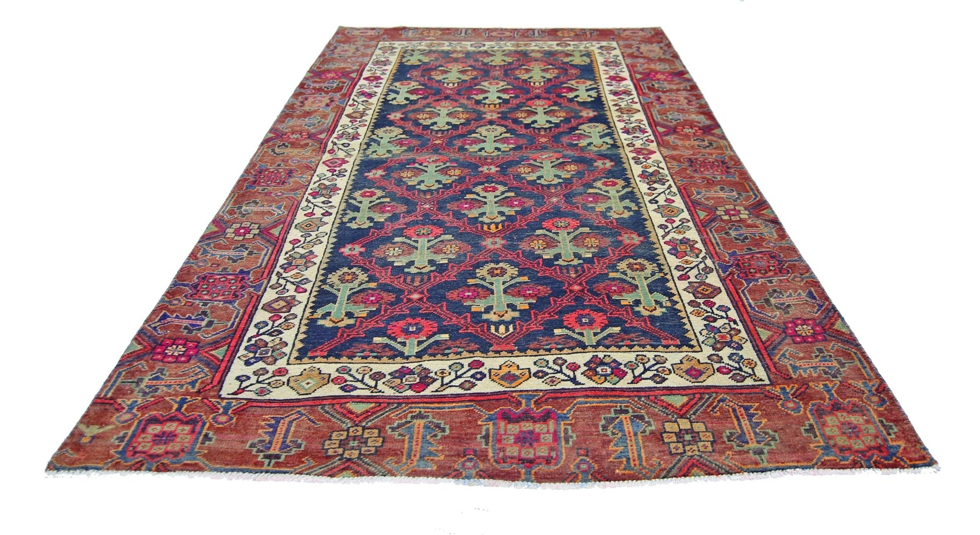 A vintage Persian Tabriz rug featuring a blue field with floral motifs and a red border.
