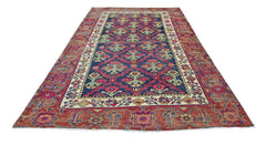 A vintage Persian Tabriz rug featuring a blue field with floral motifs and a red border.
