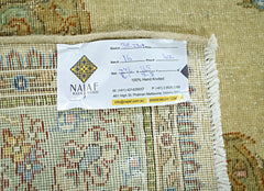 The underside of a vintage Persian Tabriz rug showing its hand-knotted construction and fringe.